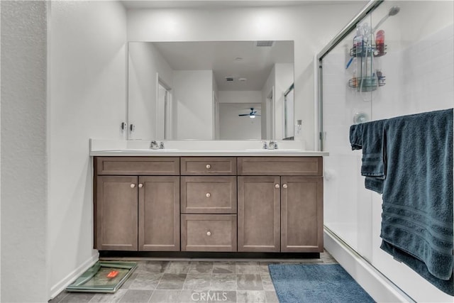 full bathroom featuring a shower stall, double vanity, and a sink