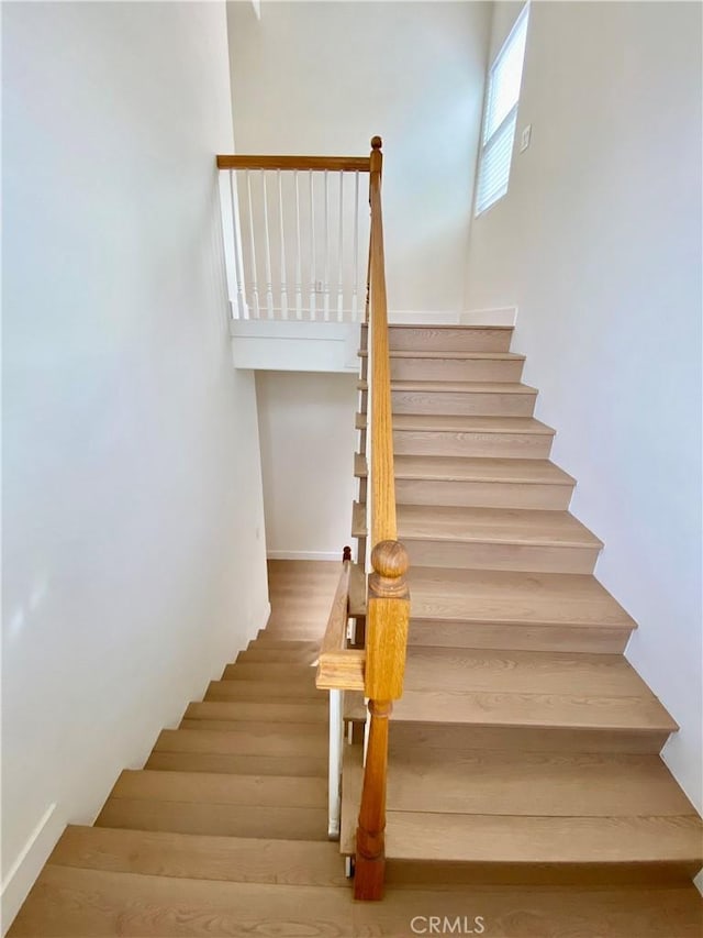 staircase featuring wood finished floors