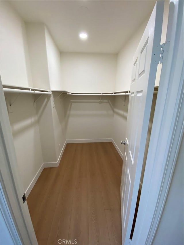 spacious closet with wood finished floors