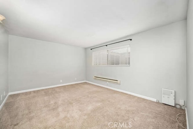 carpeted spare room with baseboards