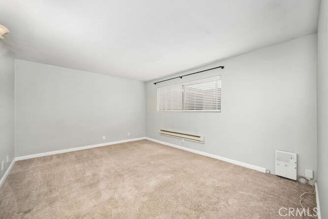 unfurnished room with carpet and baseboards