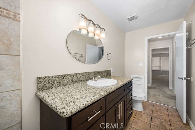 bathroom with visible vents, toilet, vanity, and tile patterned floors