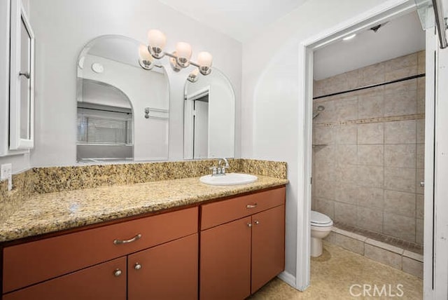 full bathroom with tiled shower, vanity, tile patterned floors, and toilet