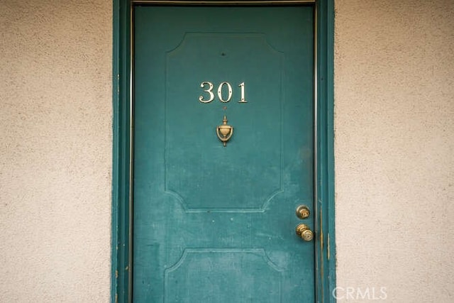 property entrance with stucco siding