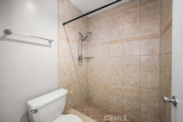 full bath featuring a tile shower and toilet