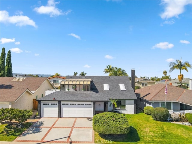 view of front facade with a shingled roof, a residential view, concrete driveway, a front yard, and a garage