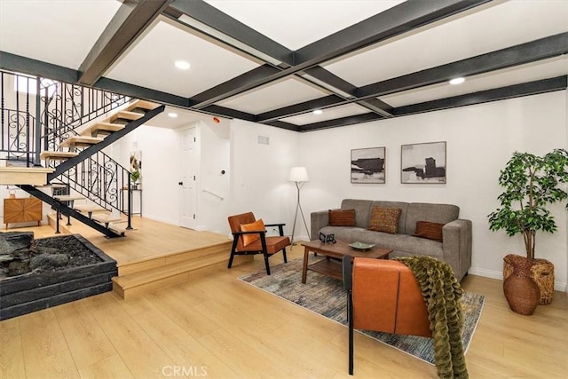 living area featuring wood finished floors, baseboards, coffered ceiling, beam ceiling, and stairs