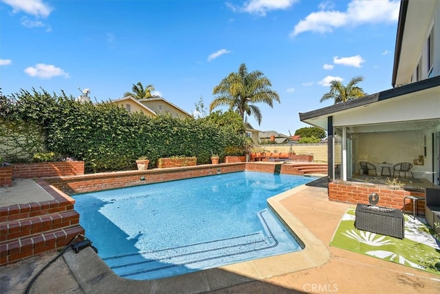 view of pool featuring a fenced in pool, a fenced backyard, and a patio area