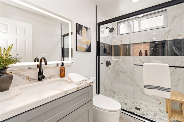 bathroom featuring vanity, toilet, and a marble finish shower