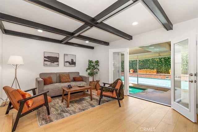 living area with beamed ceiling, recessed lighting, coffered ceiling, and wood finished floors