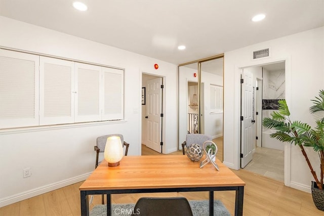 office space featuring visible vents, recessed lighting, baseboards, and light wood-style floors