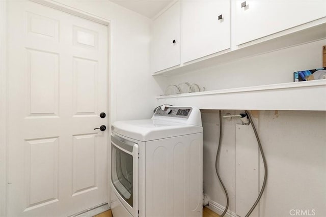 laundry area with cabinet space and washer / dryer