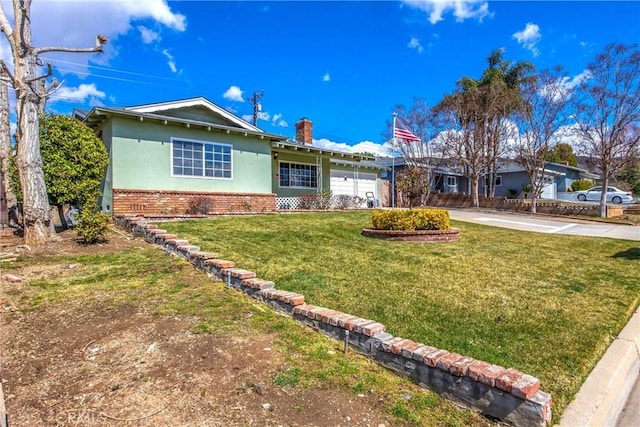 ranch-style house with stucco siding, concrete driveway, a front yard, a garage, and brick siding