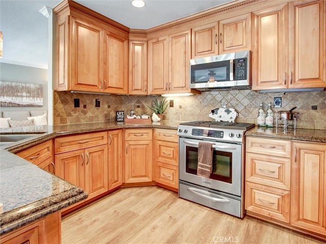 25547 Palermo Way, Yorba Linda, CA 92887 - kitchen featuring stainless steel appliances, light wood finished floors, stone countertops, tasteful backsplash, and crown molding
