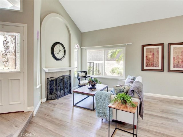 25547 Palermo Way, Yorba Linda, CA 92887 - living room with light wood-style floors, a tiled fireplace, and lofted ceiling
