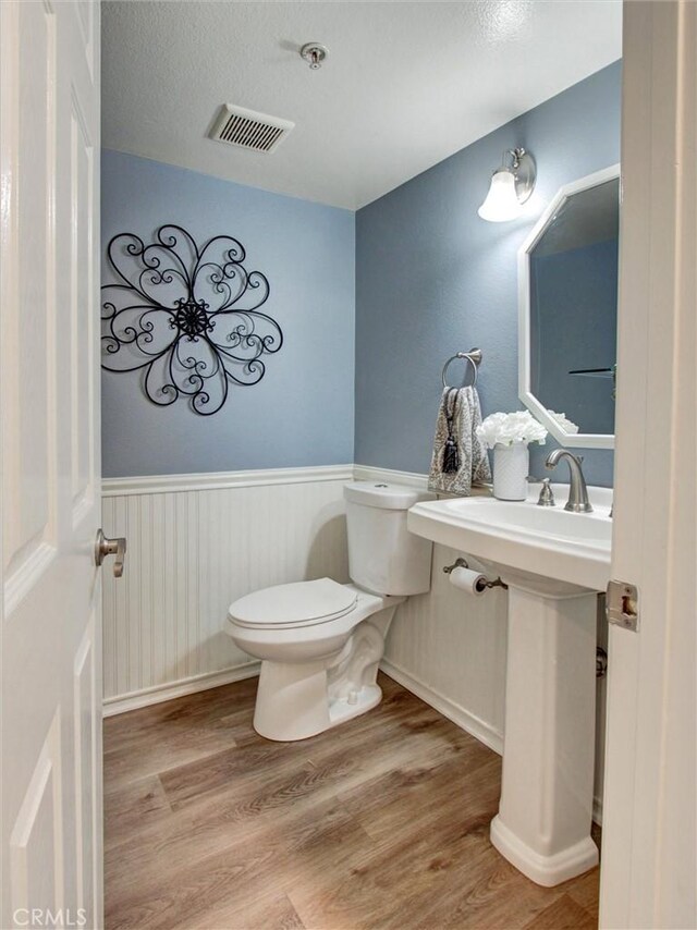 25547 Palermo Way, Yorba Linda, CA 92887 - half bathroom featuring a wainscoted wall and wood finished floors