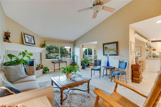 living area featuring light carpet, high vaulted ceiling, ceiling fan, and a fireplace