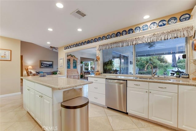 kitchen featuring visible vents, a ceiling fan, a sink, a kitchen island, and dishwasher