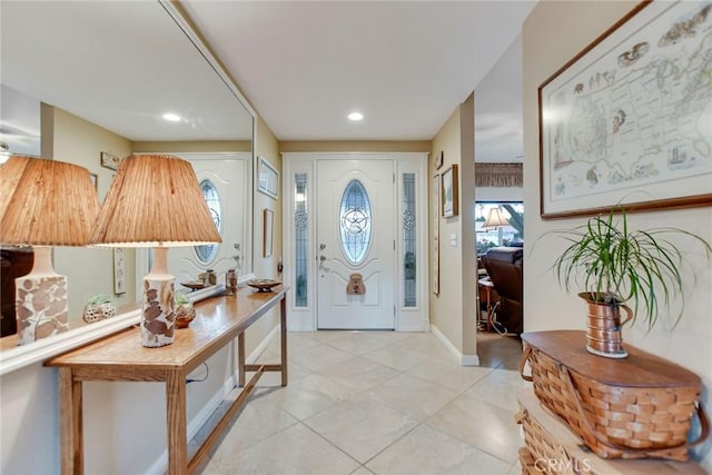 entryway featuring light tile patterned floors, baseboards, plenty of natural light, and recessed lighting