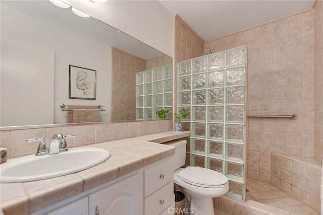 bathroom with decorative backsplash, toilet, vanity, and walk in shower