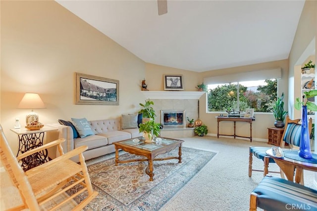 living room featuring vaulted ceiling, a tile fireplace, baseboards, and carpet floors