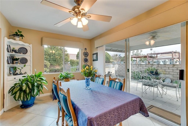 dining room featuring tile patterned flooring, ceiling fan, and baseboards