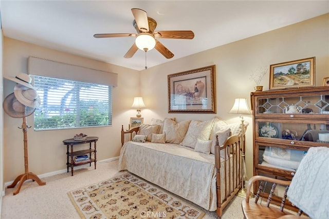 bedroom with light carpet, a ceiling fan, and baseboards