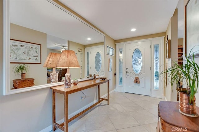 foyer featuring tile patterned floors, recessed lighting, and baseboards