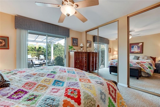 carpeted bedroom featuring multiple closets, a ceiling fan, and a sunroom