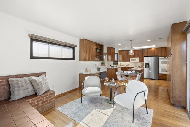 interior space featuring light wood-style flooring, recessed lighting, and baseboards