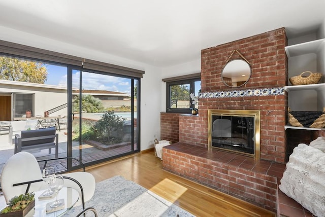 living area with wood finished floors and a fireplace