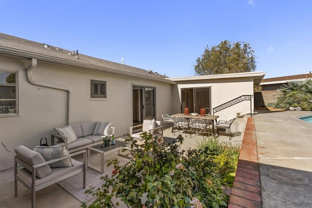 back of property featuring outdoor lounge area, a patio area, and stucco siding