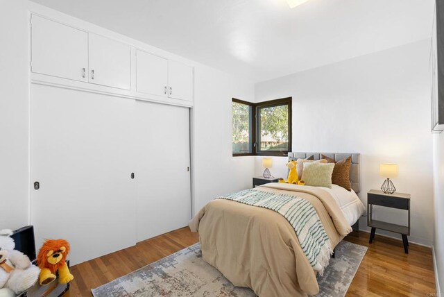 bedroom featuring a closet and light wood finished floors