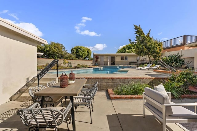 view of pool with a fenced in pool, a patio, and fence