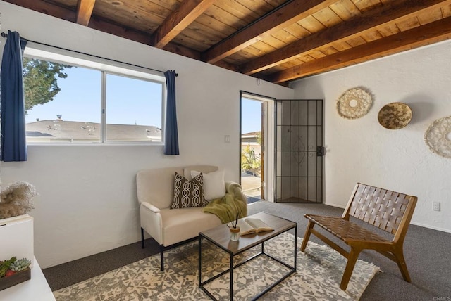 living area featuring plenty of natural light, carpet, beam ceiling, and wooden ceiling