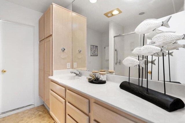 bathroom with a stall shower and vanity