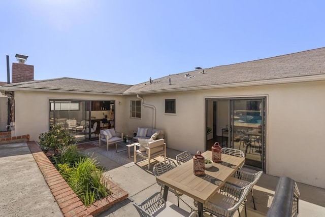 back of house featuring an outdoor living space, roof with shingles, stucco siding, a chimney, and a patio area