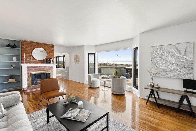 living room with wood finished floors and a fireplace