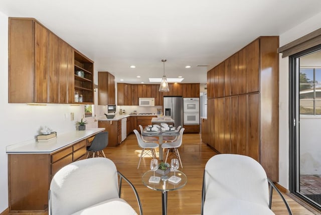 dining area with recessed lighting, light wood-type flooring, and a healthy amount of sunlight