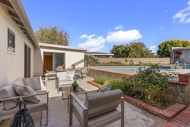 view of patio with a fenced in pool, an outdoor hangout area, outdoor dining area, and fence