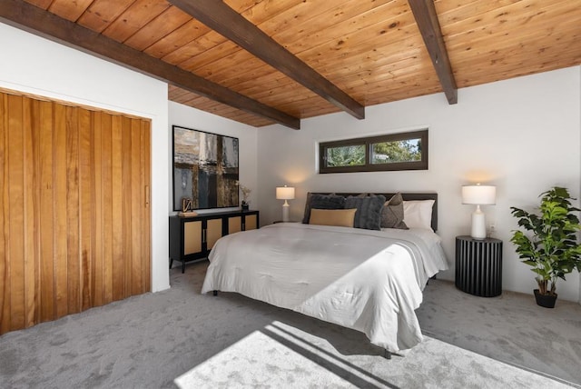 bedroom featuring lofted ceiling with beams, carpet flooring, and wood ceiling