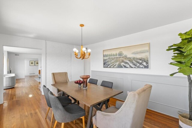 dining area featuring a notable chandelier and wood finished floors