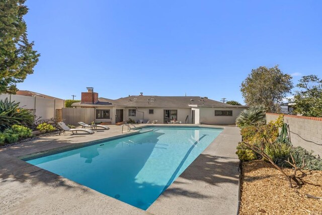 view of swimming pool with a patio, a fenced backyard, and a fenced in pool