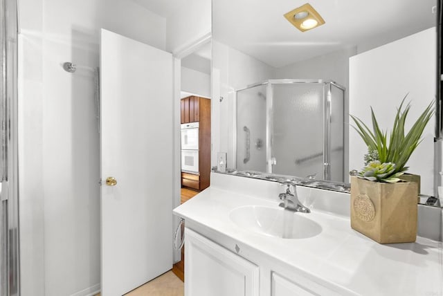 bathroom featuring vanity and a stall shower