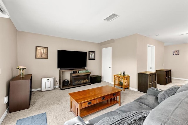 living area featuring visible vents, baseboards, and light colored carpet