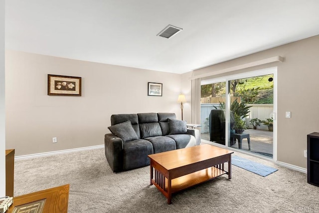 living room featuring baseboards, visible vents, and carpet floors