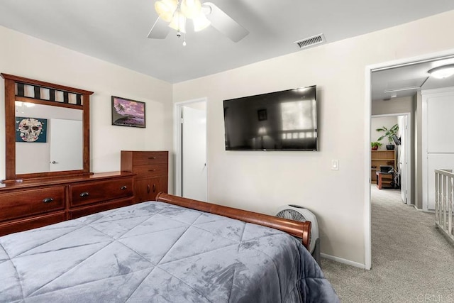 carpeted bedroom with visible vents, ceiling fan, and baseboards