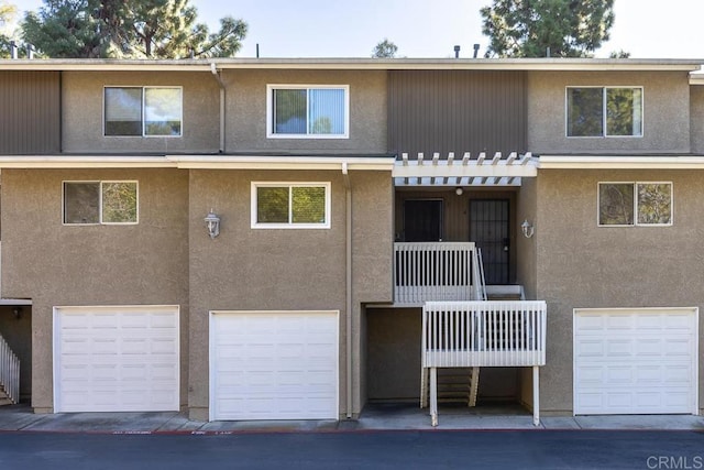 view of front facade with stucco siding and an attached garage