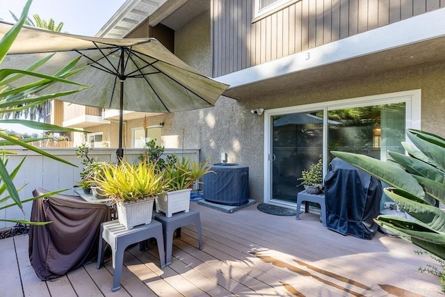 wooden deck featuring central AC unit