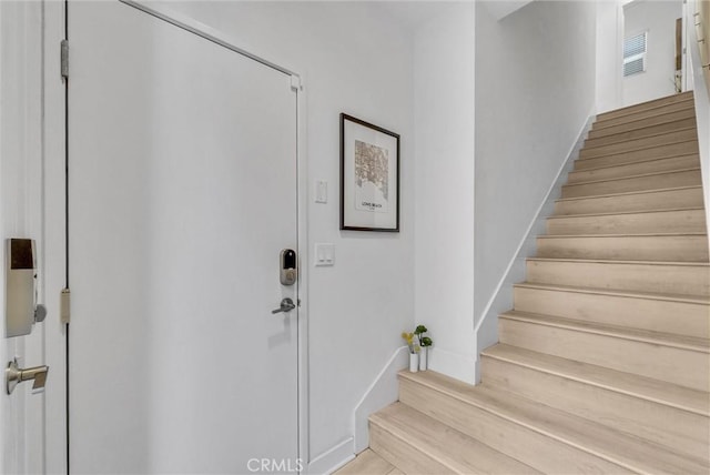 entryway with stairs and baseboards